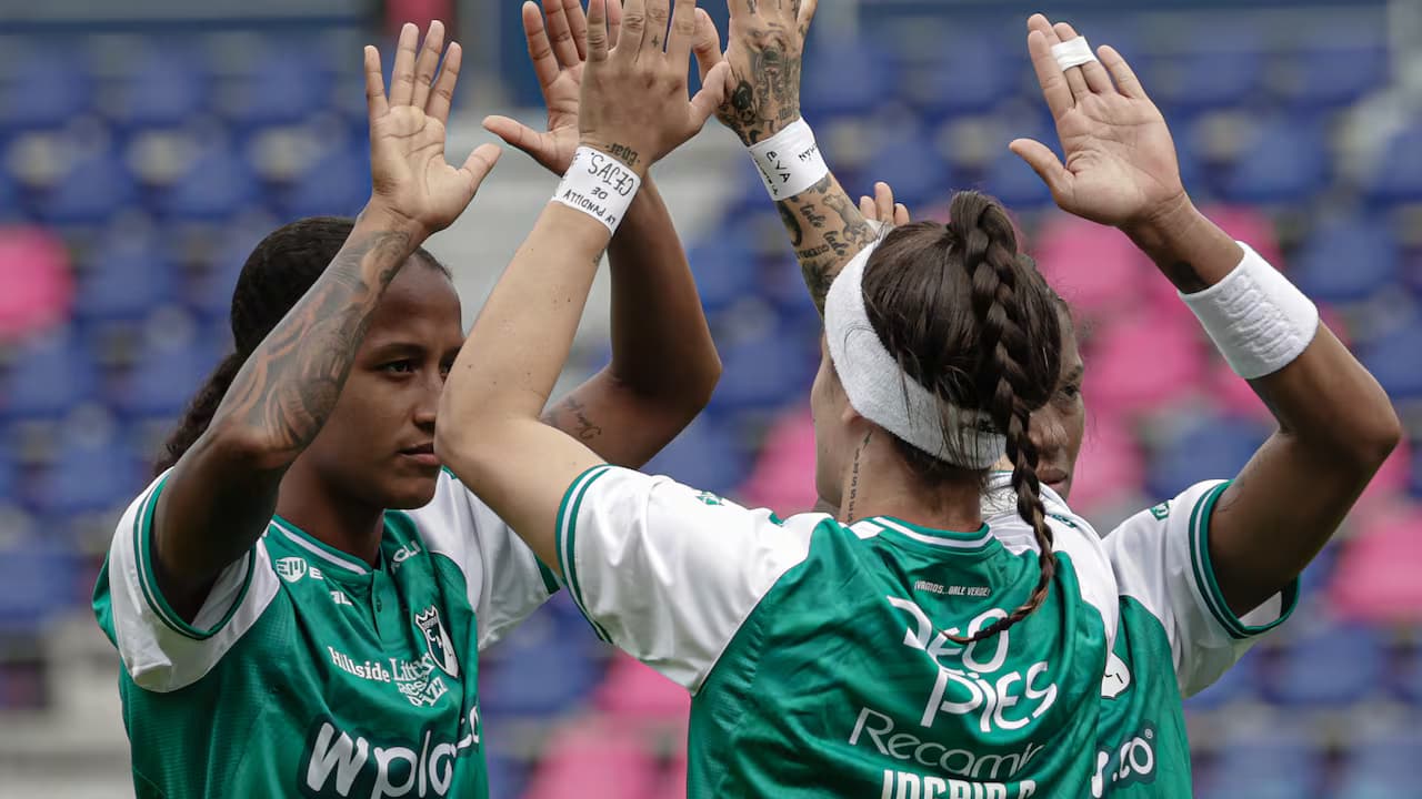 Jugadoras del Deportivo Cali chocan las manos durante el partido ante Libertad en Quito