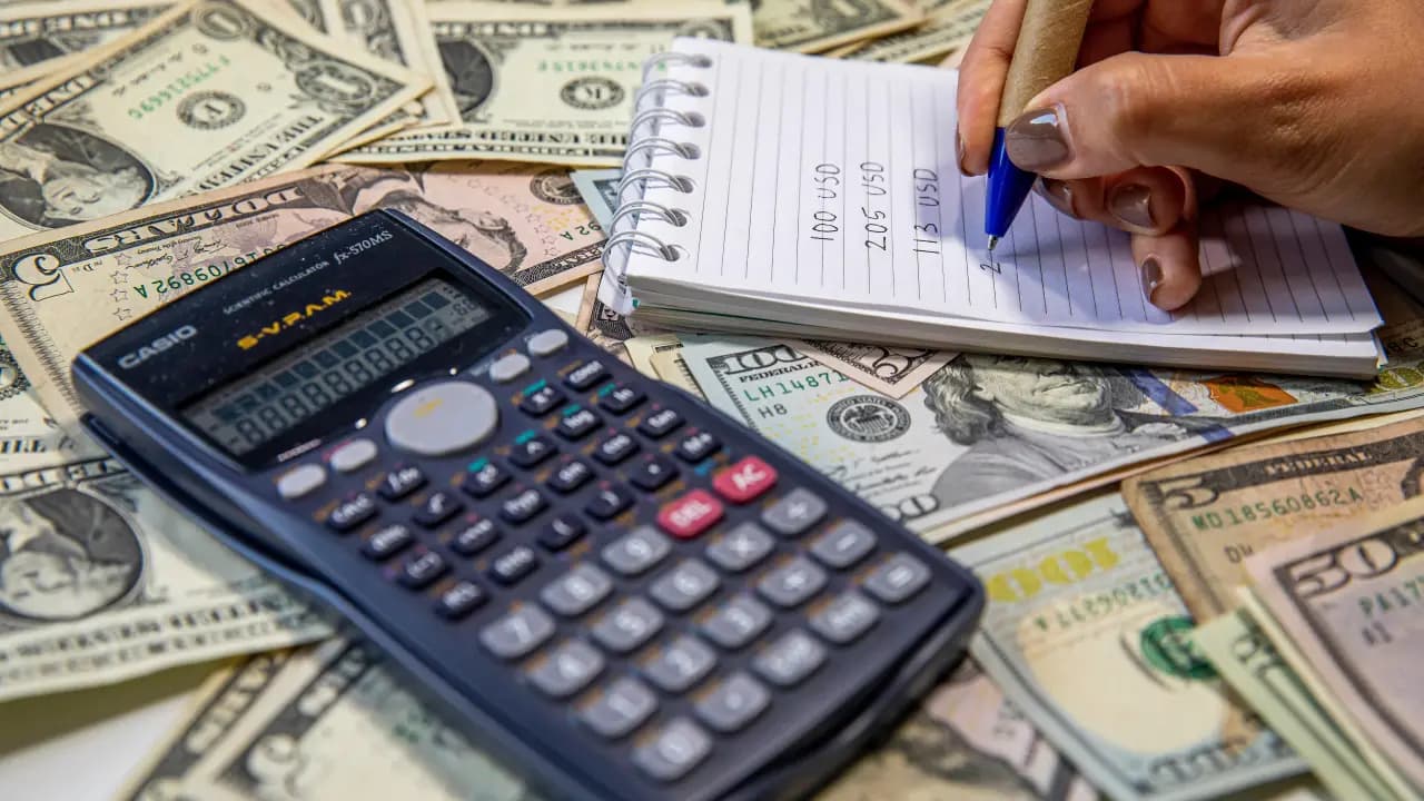 Billetes de dolar junto a una calculadora