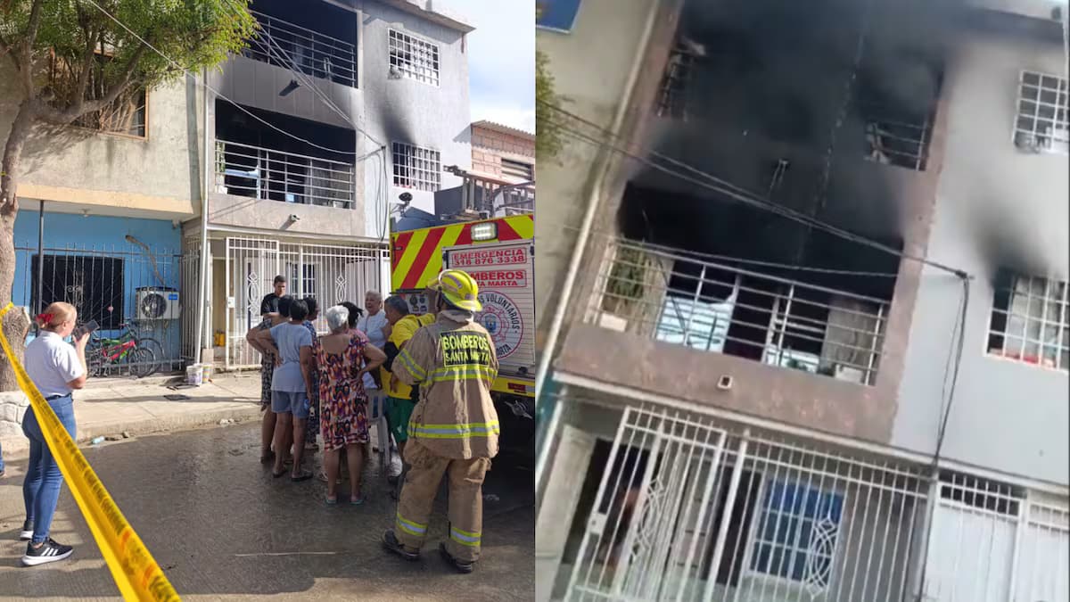 Bomberos y vecinos frente a la vivienda incendiada en el barrio Santa Cruz de Santa Marta