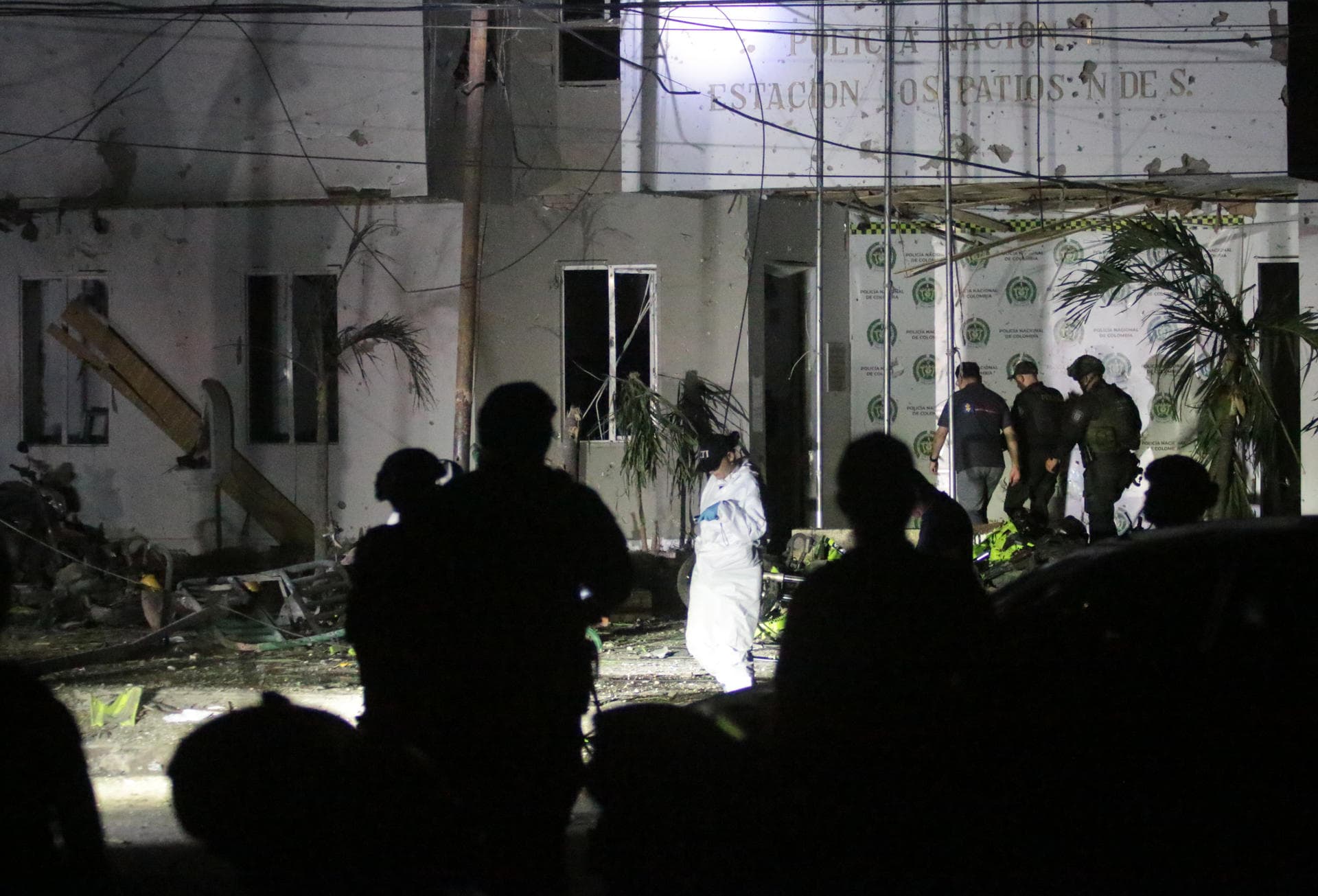 Uniformados y peritos frente a la fachada destrozada de la estación de Policía de Los Patios, en la madrugada