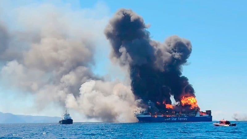 Humo negro y llamas sobre el ferri Blue Carrier 2 frente a Míkonos, con lanchas de rescate alrededor