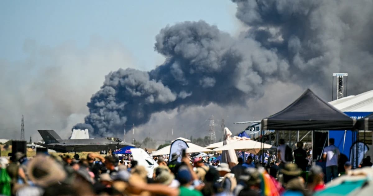 Columna de humo sobre la base aérea de Tanagra ante el público de la exhibición