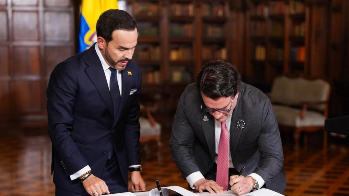 El presidente Abelardo de la Espriella firma documentos en un salón de la Casa de Nariño acompañado por un funcionario