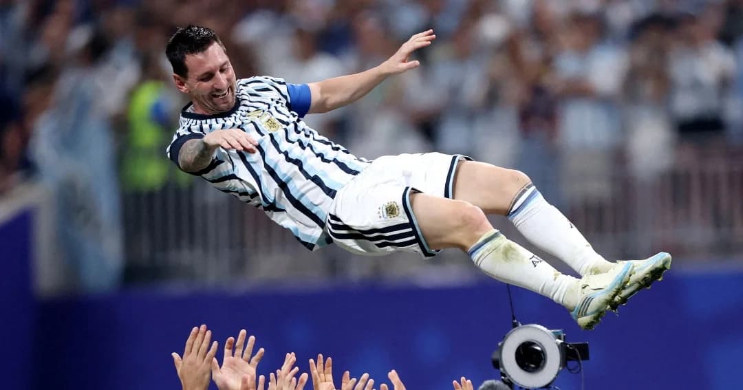 Lionel Messi, con la camiseta de la selección argentina, es lanzado al aire por sus compañeros en un estadio lleno