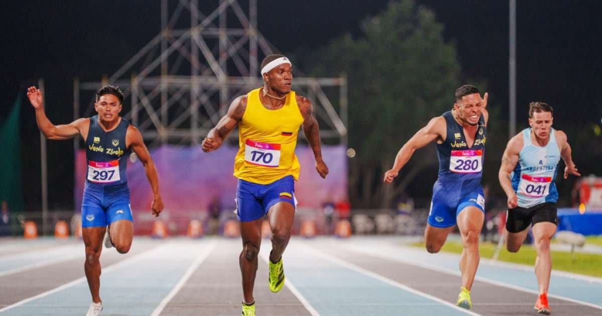 Ronal Longa, con el uniforme amarillo de Colombia, cruza la meta por delante de sus rivales en la pista de Santa Fe