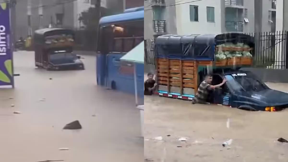 Vehículos atrapados en una calle inundada de Santa Marta tras el aguacero del sábado
