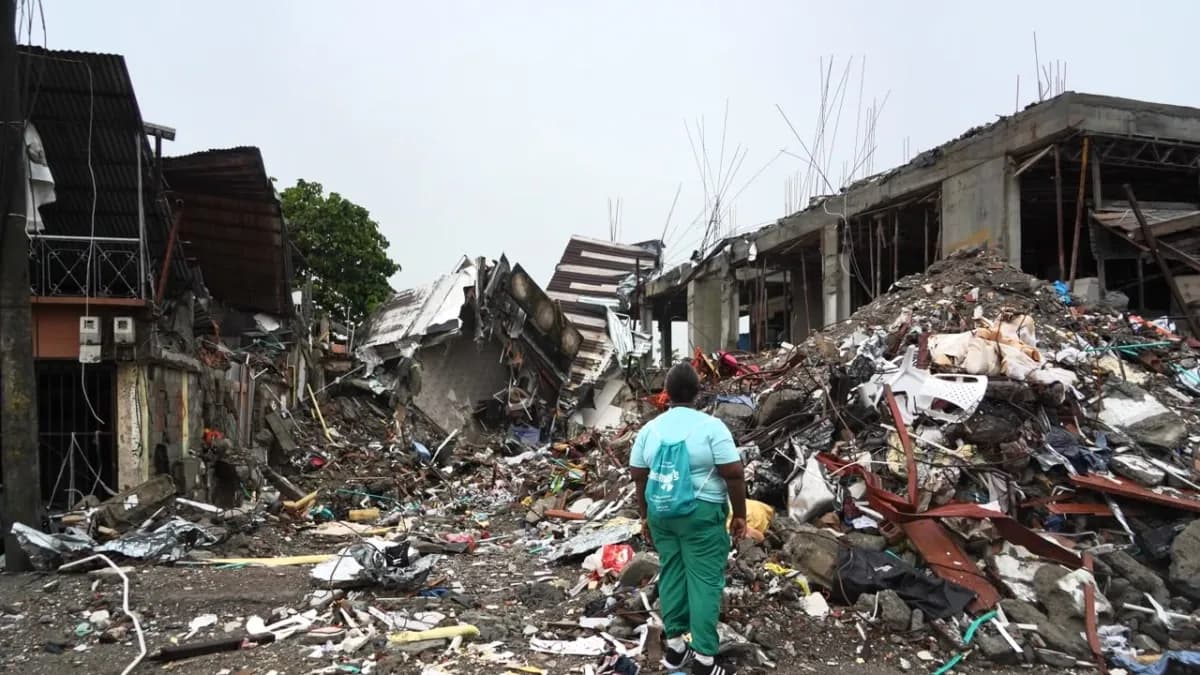 Familias damnificadas por el terremoto frente a una vivienda destruida