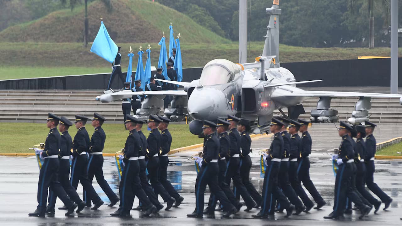 Cadetes desfilan frente a un avión de combate Gripen en una ceremonia militar