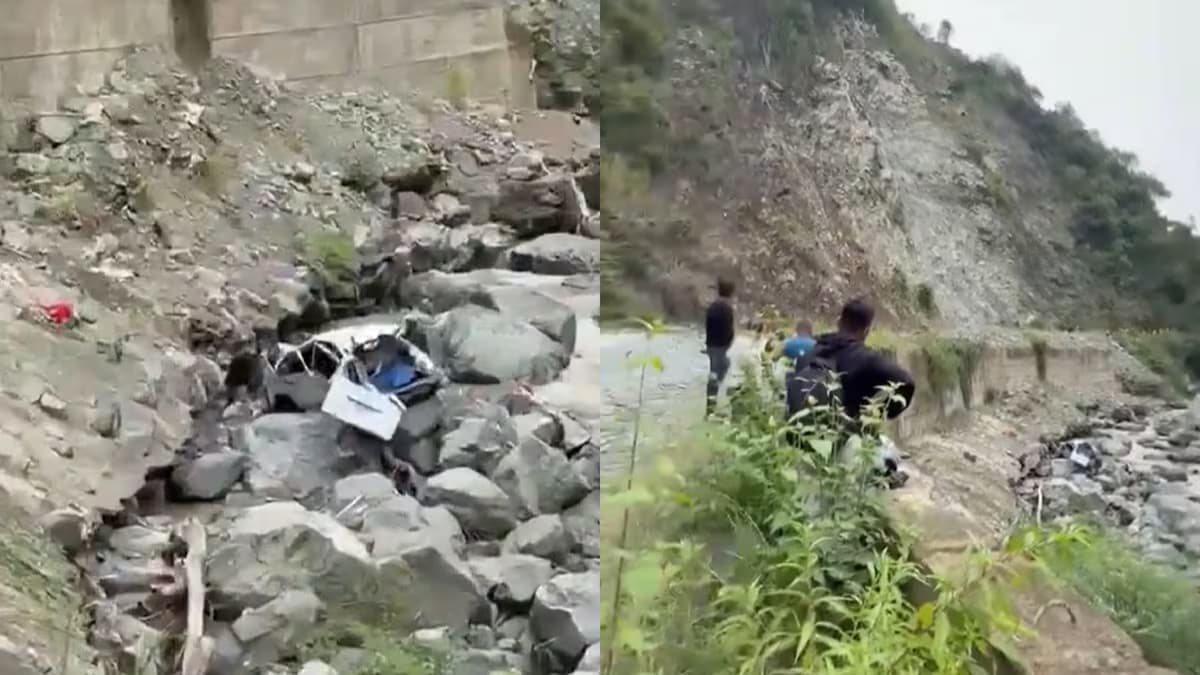 Restos del microbús entre las rocas, a orillas del río, y vecinos que acuden al lugar del accidente en Salgar