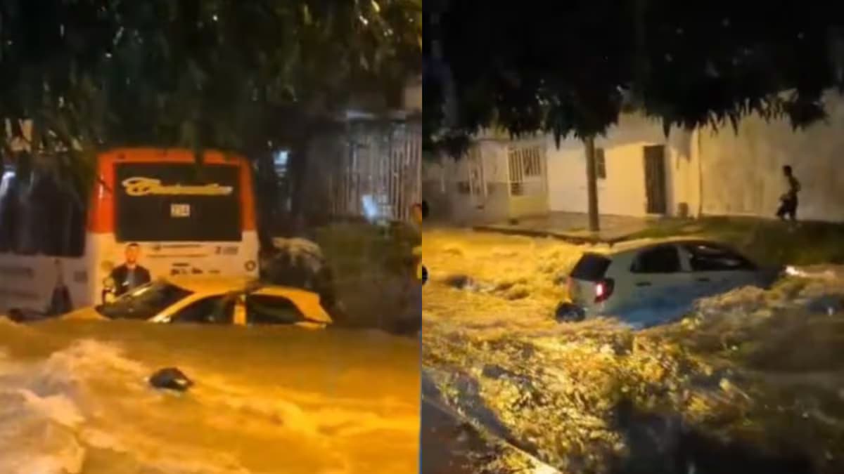 Un taxi atrapado por la corriente del arroyo El Salao, detenido contra un bus, en Soledad