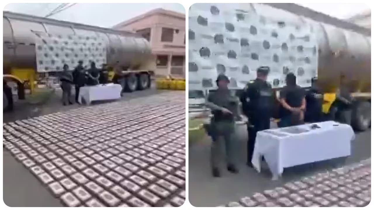 Policías custodian a un capturado junto a un tractocamión y cientos de paquetes de cocaína alineados en el suelo en Palmira