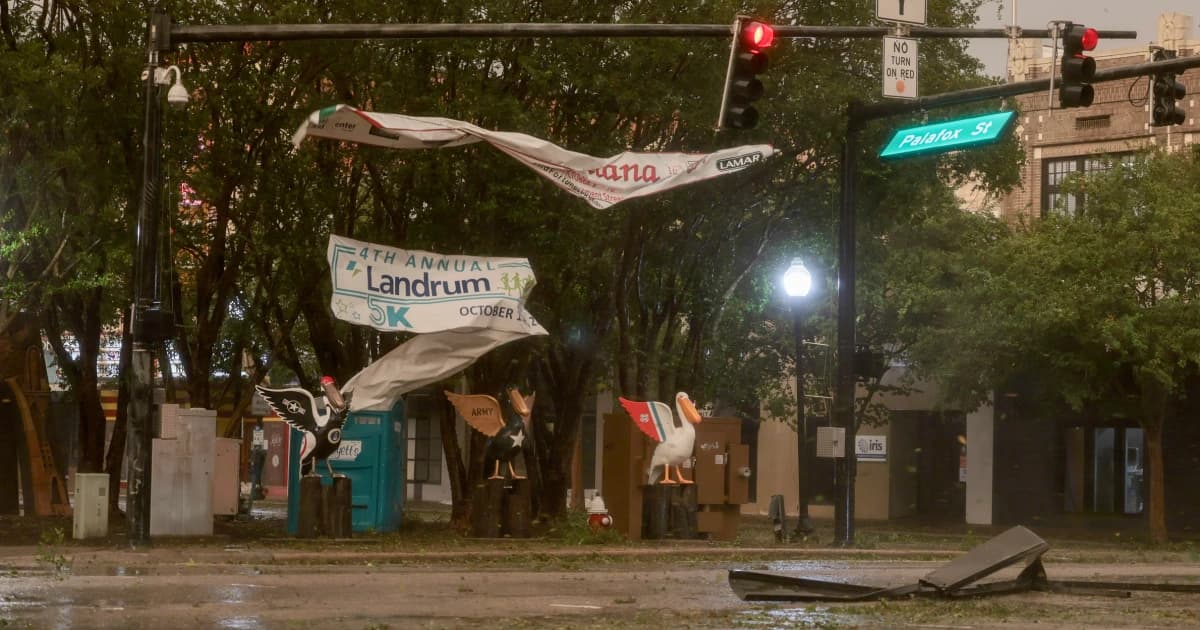 Pancartas rotas y escombros en una calle de Pensacola, Florida, tras el paso del huracán Isaías